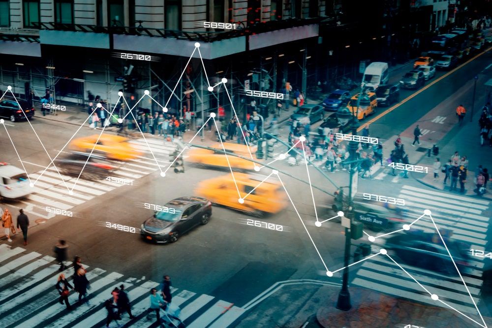 A busy city road with taxis and people
